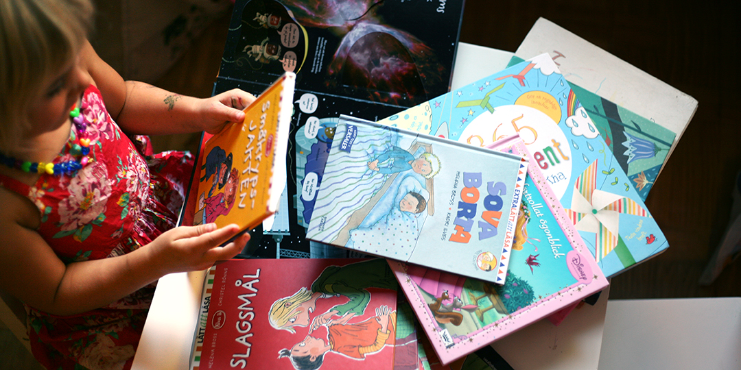 Förskolebarn tittar intresserat på nya barnböcker