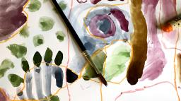 En målning med vattenfärg på papper samt en pensel.