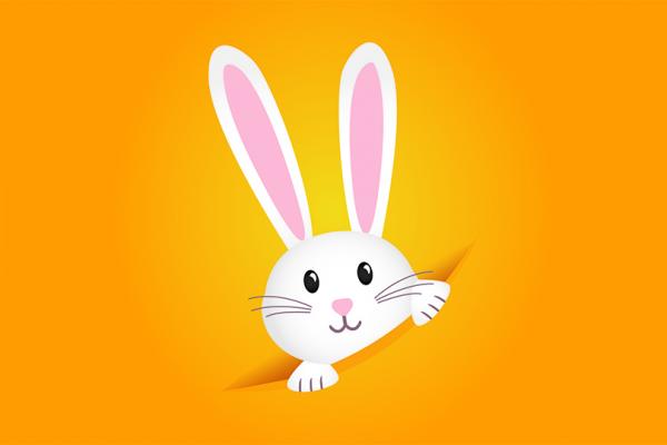 En hare med långa öron tittar upp ur ett hål.